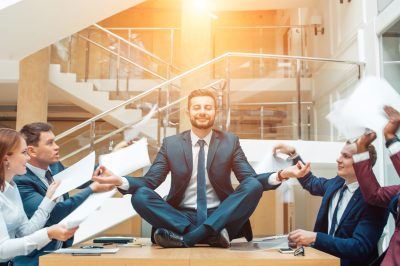 young handsome business man in black suit practice yoga and relax at office massages entreprise Lyon séminaires